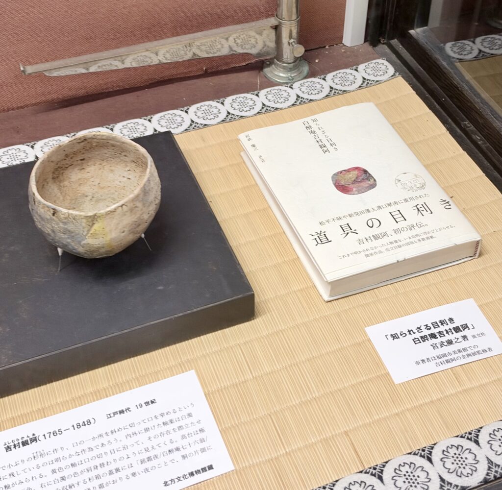 吉村観阿の茶碗と書籍『道具の目利き』を並べた北方文化博物館の展示